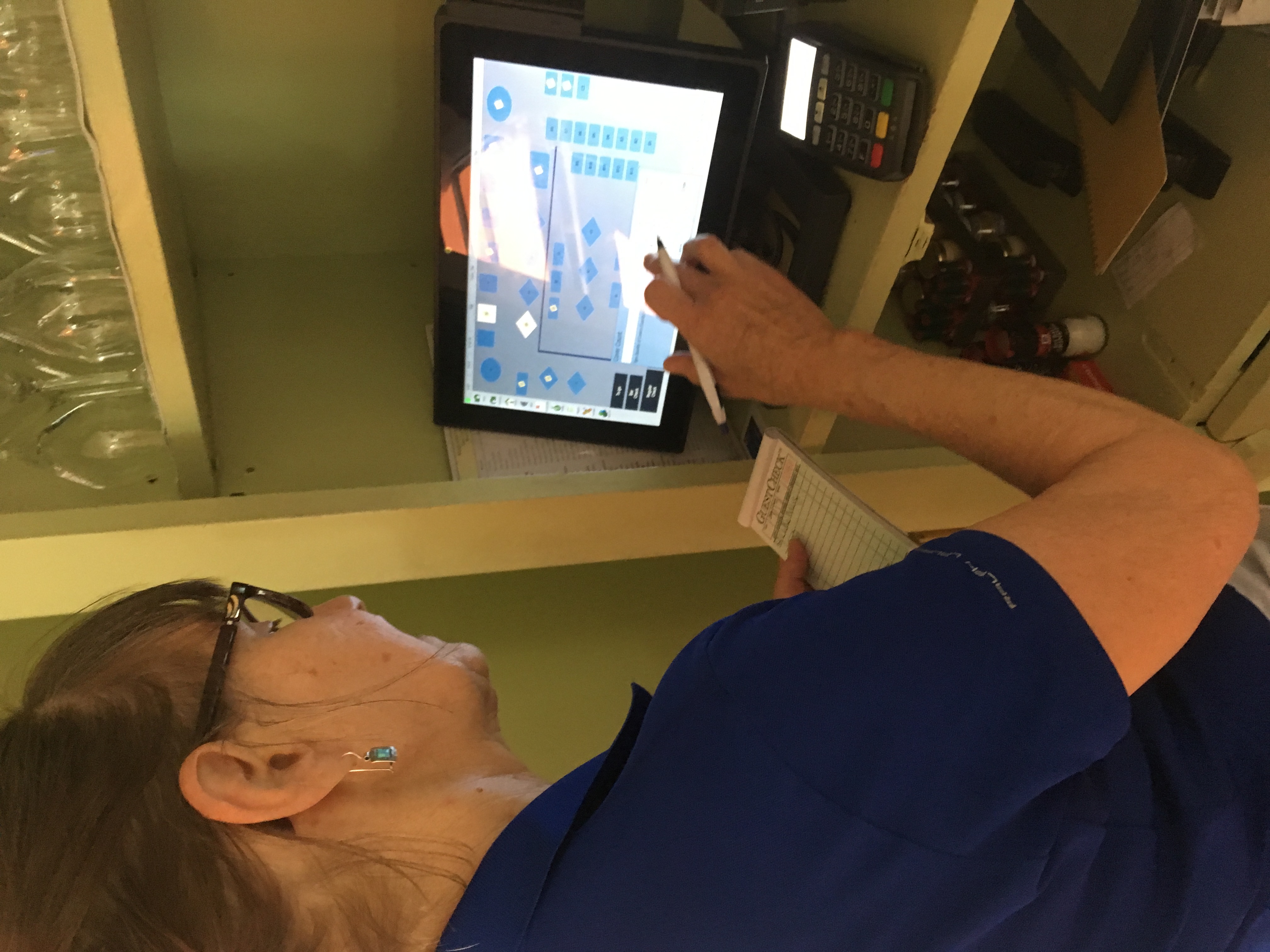 Server using a POS tablet in the restaurant